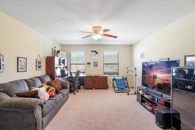 living area featuring light colored carpet, a textured ceiling, and a ceiling fan
