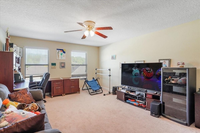 office area featuring light carpet, baseboards, a textured ceiling, and a ceiling fan