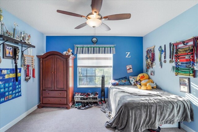 carpeted bedroom featuring a ceiling fan and baseboards