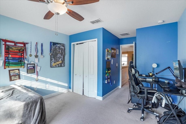 home office featuring a ceiling fan, visible vents, carpet floors, and baseboards