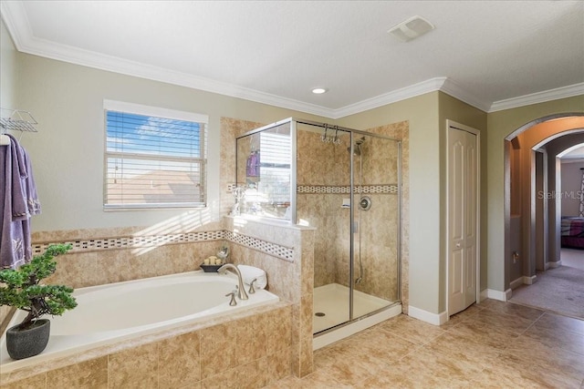 bathroom with a bath, visible vents, a stall shower, and crown molding