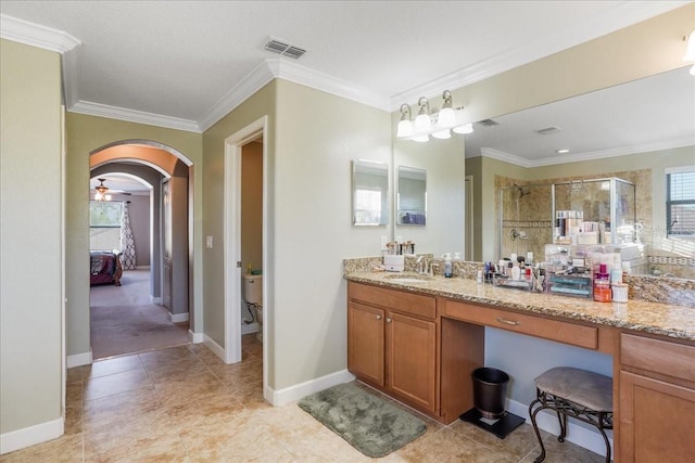 bathroom with vanity, visible vents, a stall shower, and ornamental molding