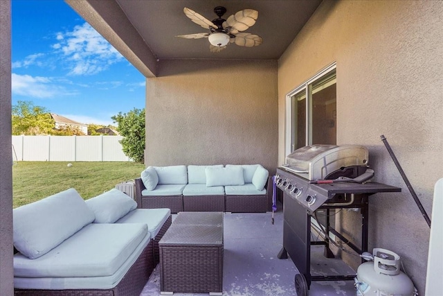 view of patio with an outdoor living space, ceiling fan, and fence
