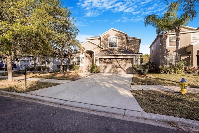traditional-style house with an attached garage, driveway, and stucco siding