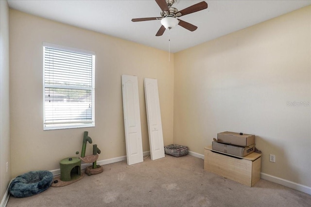 unfurnished bedroom featuring baseboards, carpet floors, and ceiling fan