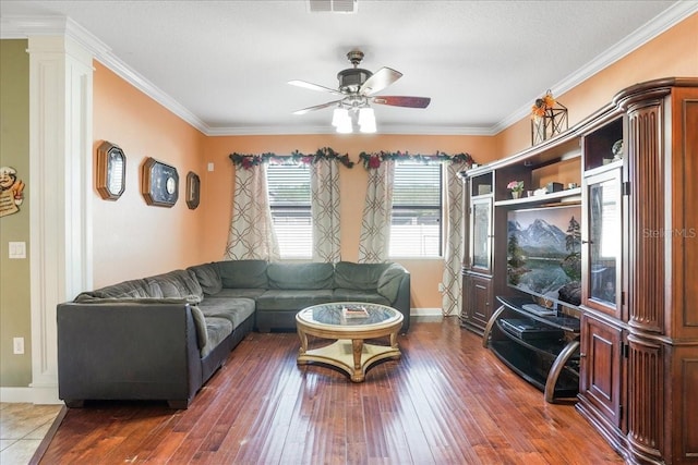 living area with baseboards, ceiling fan, ornamental molding, and hardwood / wood-style flooring