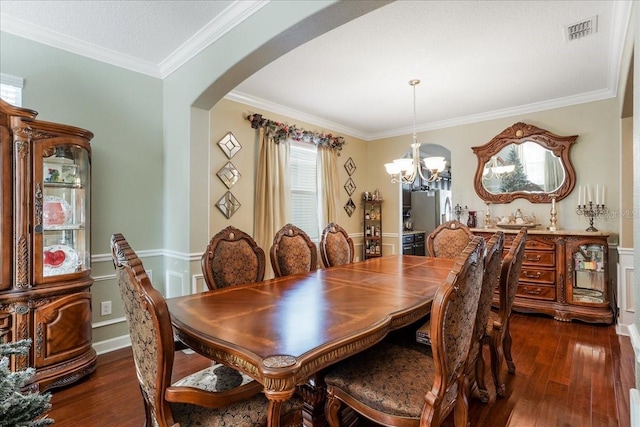 dining room featuring dark wood finished floors, a notable chandelier, arched walkways, and visible vents