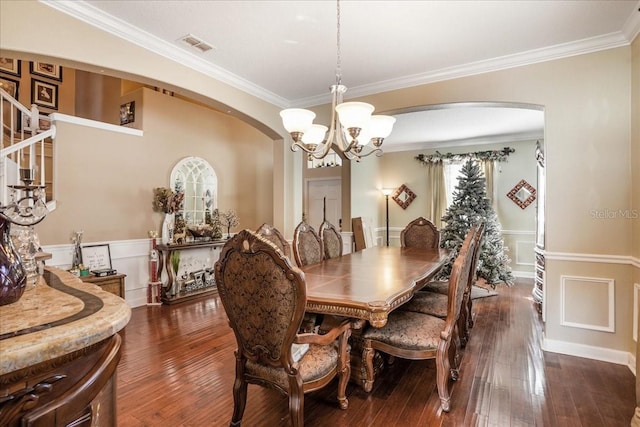 dining room with arched walkways, a notable chandelier, dark wood-type flooring, and visible vents