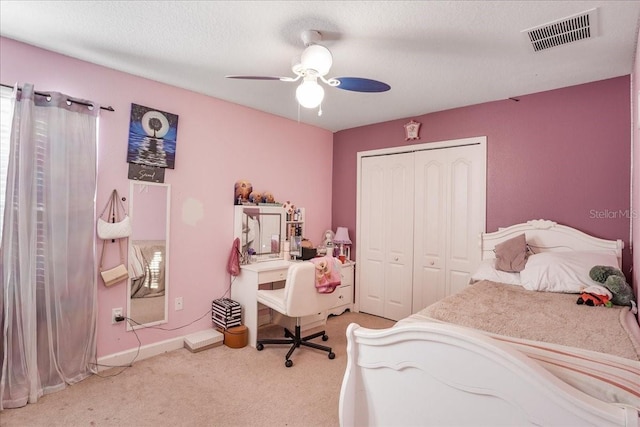bedroom with visible vents, a ceiling fan, a closet, carpet floors, and baseboards