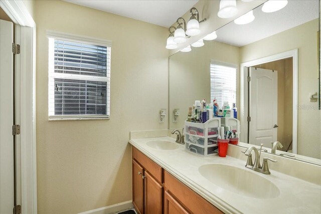 full bath with a sink and double vanity
