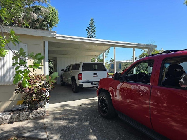 view of vehicle parking featuring an attached carport and driveway