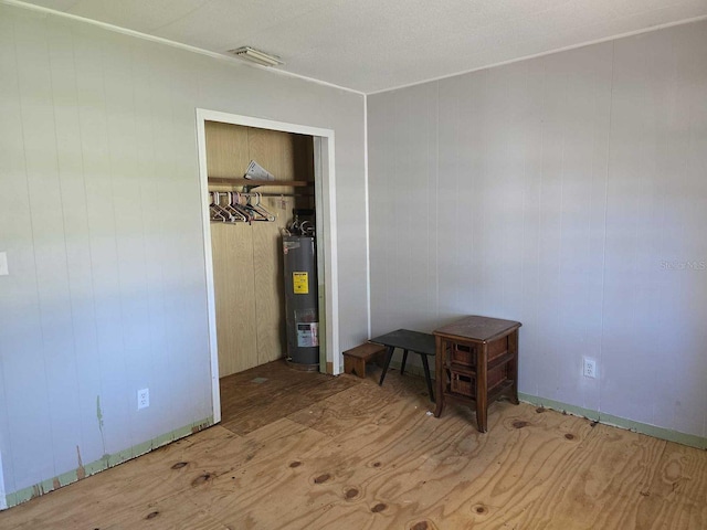 bedroom with visible vents and electric water heater