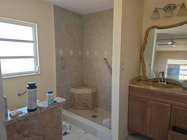 full bathroom with vanity, a tile shower, and ceiling fan