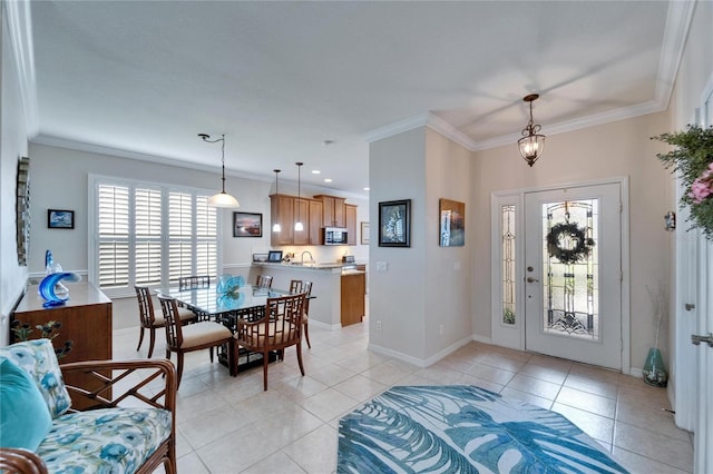 foyer entrance with baseboards, light tile patterned flooring, and crown molding