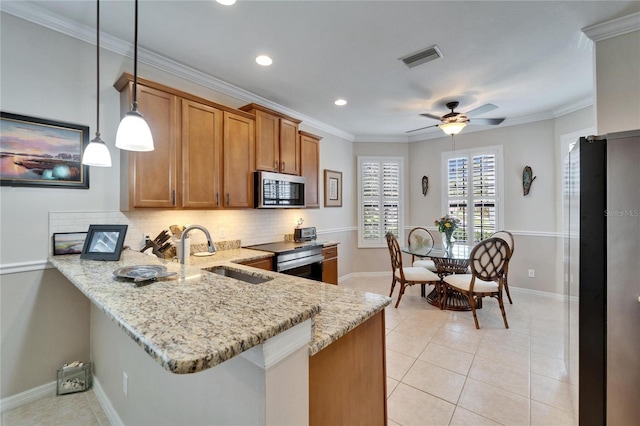 kitchen with brown cabinetry, a peninsula, light tile patterned flooring, a sink, and stainless steel appliances