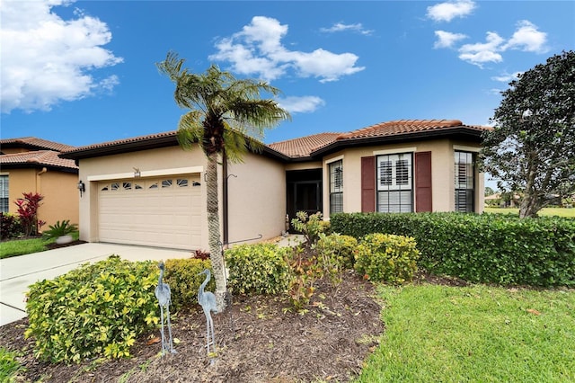 view of front facade featuring a tiled roof, a garage, driveway, and stucco siding