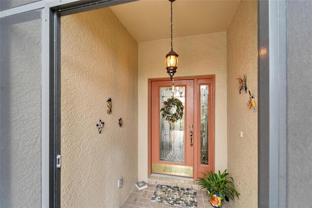 property entrance featuring stucco siding