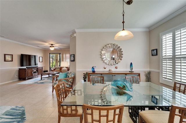 dining area featuring light tile patterned floors, baseboards, crown molding, and ceiling fan