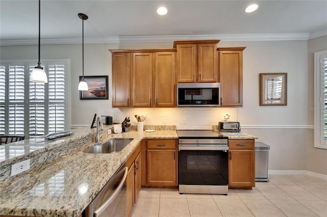 kitchen with decorative backsplash, crown molding, appliances with stainless steel finishes, and a sink