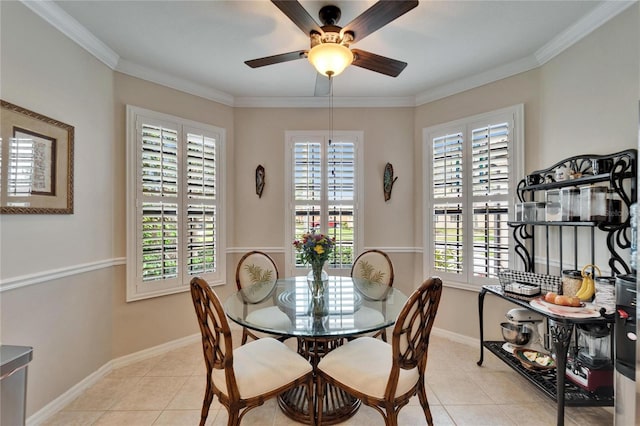 dining room featuring light tile patterned floors, a ceiling fan, crown molding, and baseboards