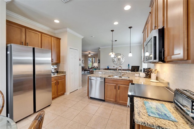 kitchen with a sink, a peninsula, brown cabinets, and stainless steel appliances