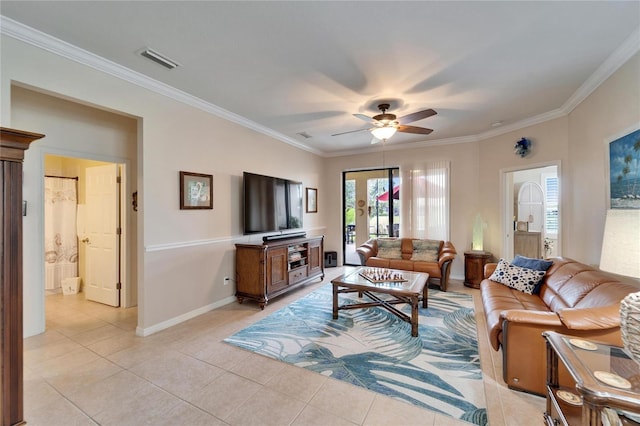 living room featuring visible vents, crown molding, baseboards, ceiling fan, and light tile patterned floors