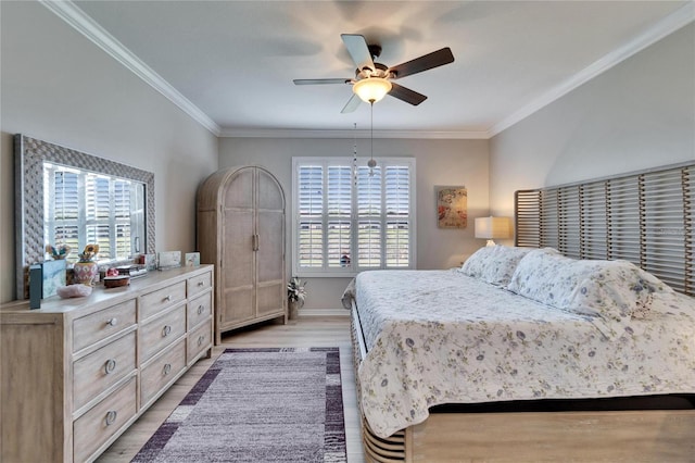 bedroom with crown molding, a ceiling fan, light wood-type flooring, and baseboards