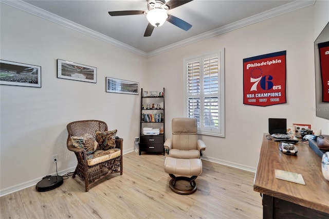 living area with crown molding, baseboards, light wood finished floors, and ceiling fan