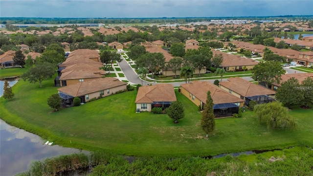 bird's eye view with a residential view and a water view