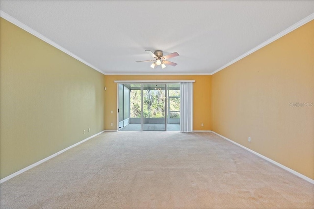 empty room with ornamental molding, carpet floors, and baseboards