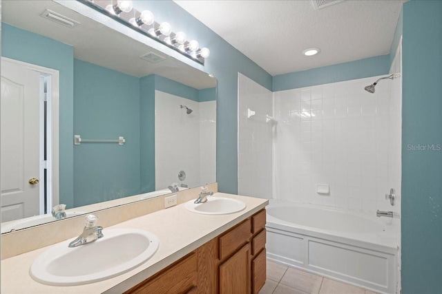 full bath featuring a textured ceiling, bathtub / shower combination, a sink, and tile patterned floors