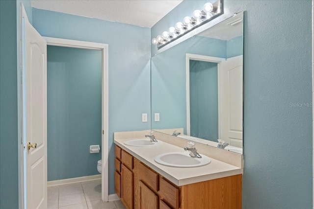 bathroom featuring tile patterned flooring, a sink, and toilet