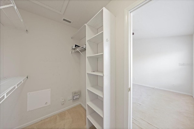 walk in closet featuring visible vents and carpet flooring