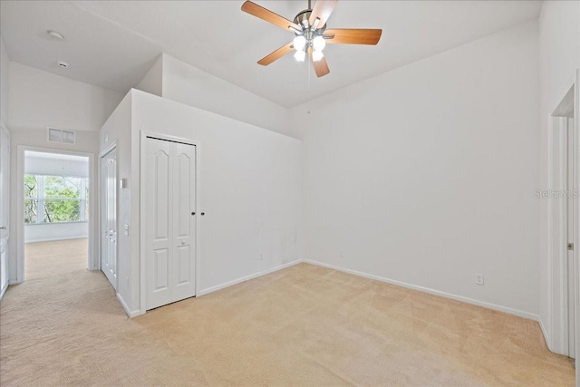 empty room with light carpet, visible vents, and baseboards