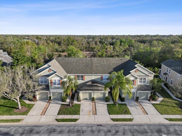 drone / aerial view featuring a forest view