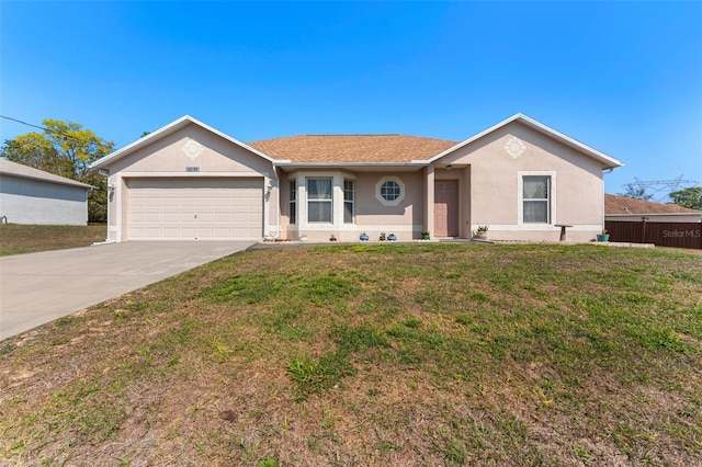 single story home with stucco siding, an attached garage, driveway, and a front yard