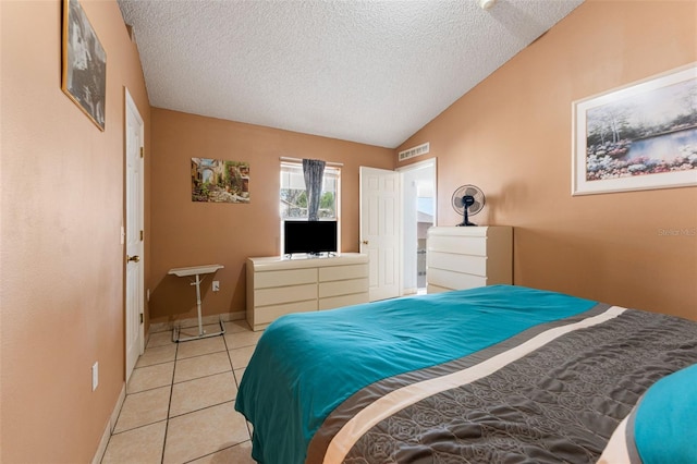 bedroom featuring visible vents, a textured ceiling, baseboards, light tile patterned floors, and lofted ceiling