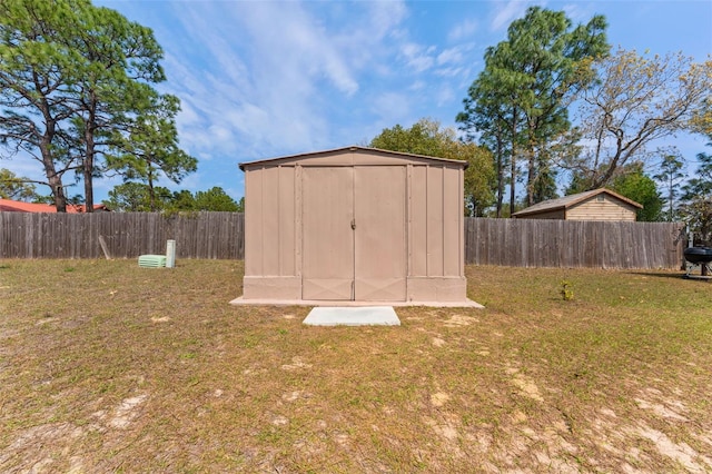 view of shed with a fenced backyard