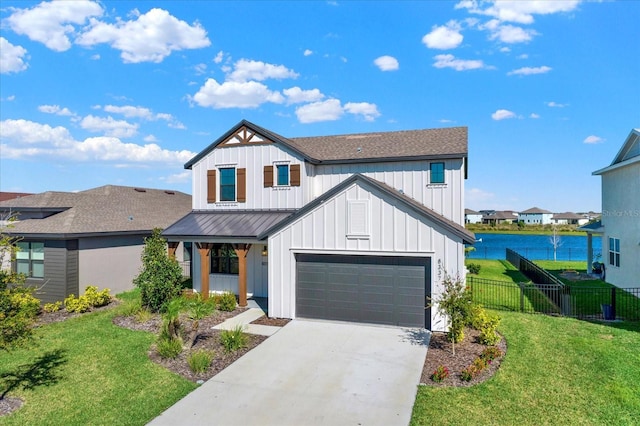 modern inspired farmhouse with fence, driveway, a front lawn, a garage, and board and batten siding