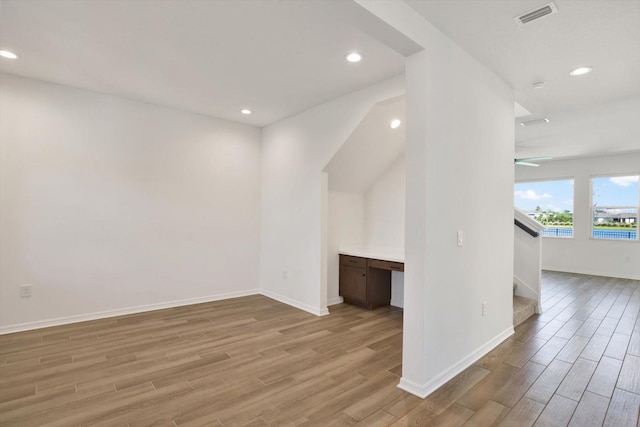 interior space featuring stairway, visible vents, light wood finished floors, baseboards, and recessed lighting