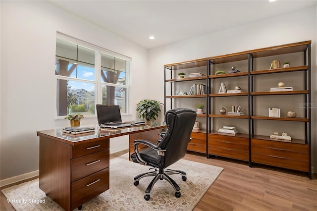 office space with recessed lighting, light wood-type flooring, and baseboards