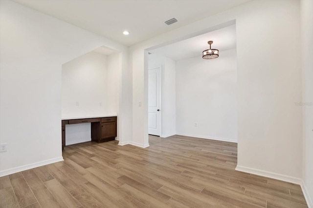 unfurnished living room featuring recessed lighting, visible vents, light wood-style flooring, and baseboards