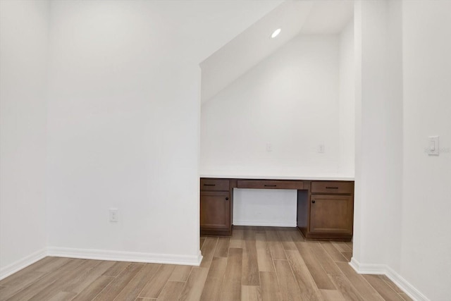 interior space featuring light wood-type flooring, baseboards, and built in study area