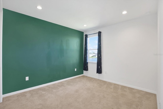 unfurnished room featuring recessed lighting, carpet, and baseboards