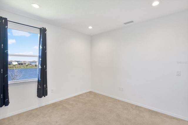 empty room featuring baseboards, light carpet, and a healthy amount of sunlight