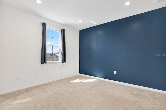 carpeted empty room with recessed lighting and baseboards