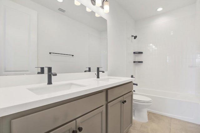 full bath featuring tile patterned floors, toilet, double vanity, and a sink