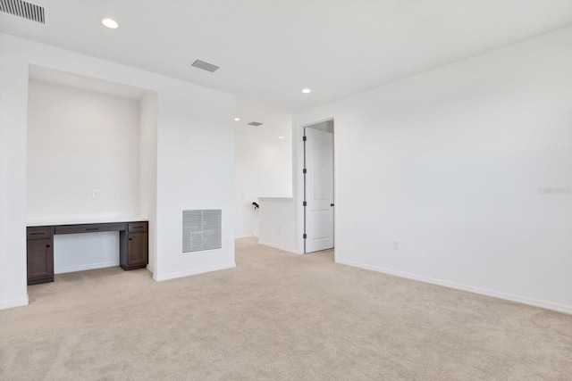 spare room with recessed lighting, visible vents, and light carpet