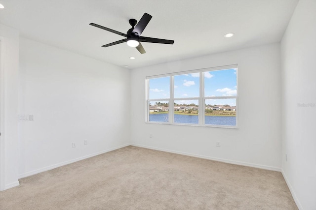 empty room featuring recessed lighting, baseboards, light colored carpet, and a ceiling fan