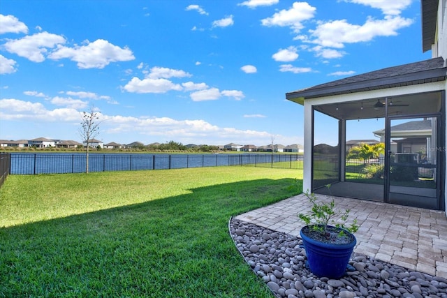 view of yard with a patio area, a residential view, a fenced backyard, and a sunroom